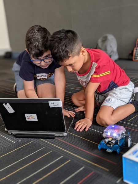 Two Boys Working on the laptop to control their educational robot, mBot.