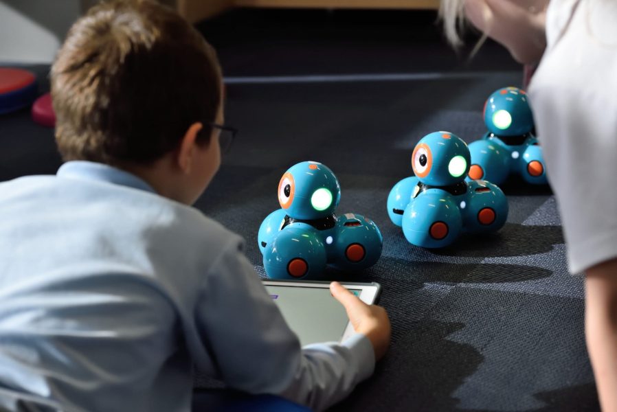 Kid playing with robots